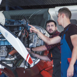A mechanic and pilot next to an aircraft