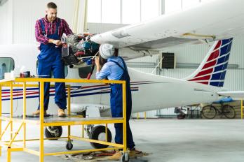 Two mechanics working at an aircraft