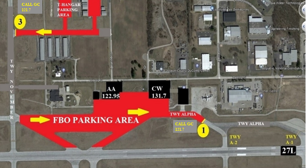 A satellite photo of the east corner of the South Bend International Airport airfield including east runway 27 left, taxiway Alpha, taxiway November, and taxi-lane Tango. If the ATIS is advising runway 27 left, this photo shows highlighted in red the FBO parking and t-hangar parking areas with the direction to proceed.