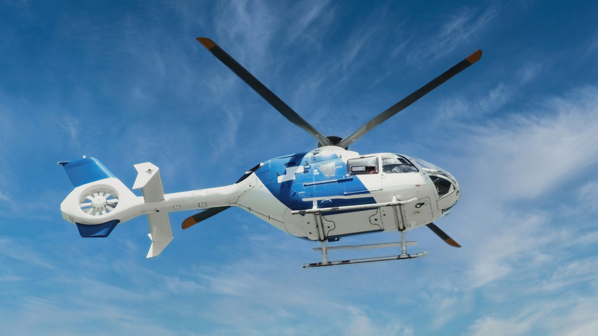 blue helicopter air ambulance flying in clear sky