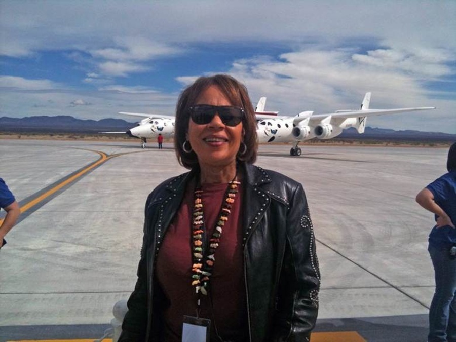 Patti Grace Smith standing outside near a runway