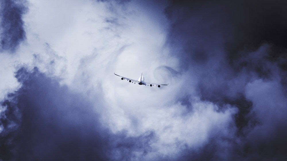Plane flying into clouds