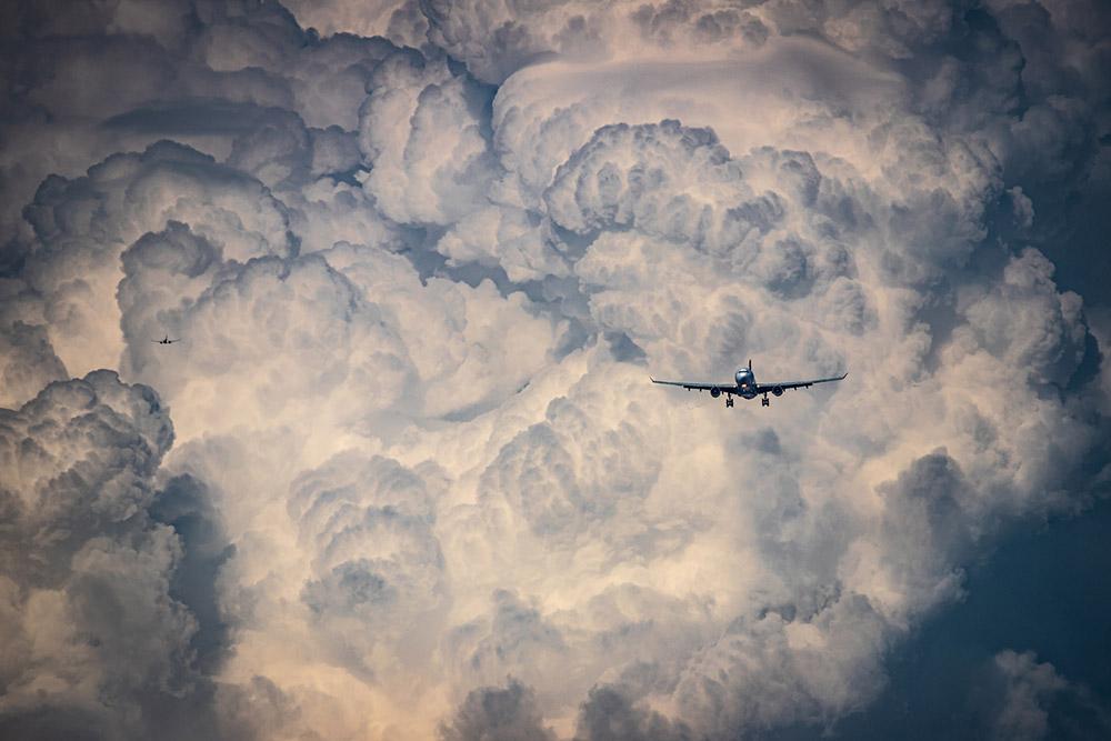 Plane landing with clouds in background