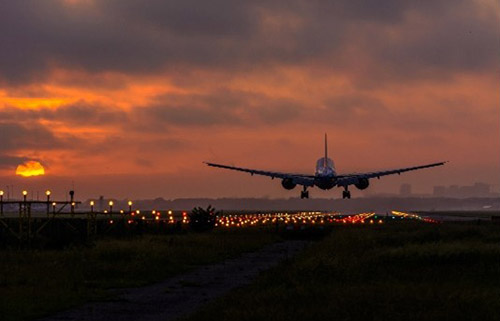 Airliner landing at sunset
