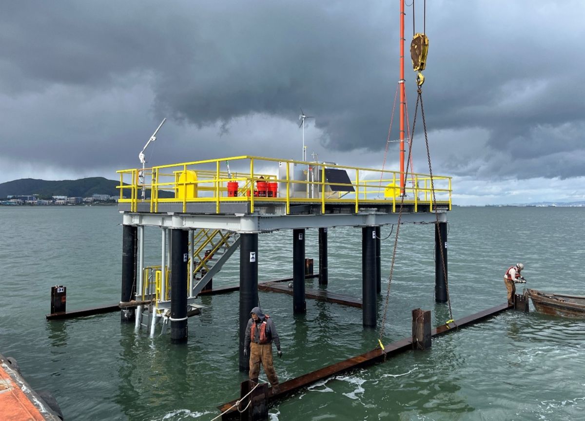 Tech Ops personnel at work on a platform over water