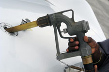A man pumping gasoline into an aircraft.