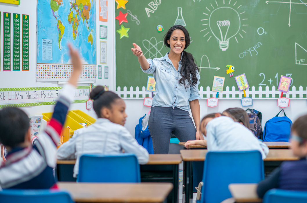 teacher in front of class with student raising hand