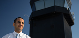 man standing in front of an air traffic control tower