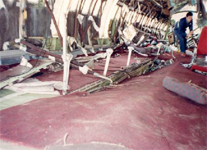 "Photo of cabin center section. Note separated seat legs still attached to floor. Photo from NTSB/FAA investigation."