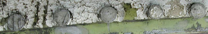 "Photo of crack propagated along of skin scratch just outside line of rivets"