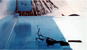 "Photo of Damage to the left wing of F-BVSC due to penetration from #5 wheel debris"