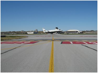 "Photo of typical hold-short line on runway identification"