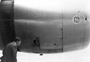 "Photo of No. 1 engine cowl showing impact damage"
