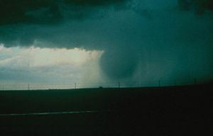 "Photo of Horizontal vortex ring caused by outflow gust front interacting with surrounding atmosphere"