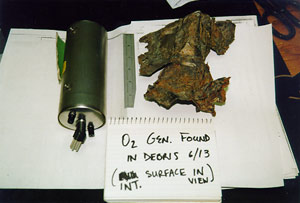 "NTSB photo of recovered oxygen generator"