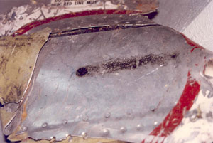 "NTSB photo of external soot trail behind opening"