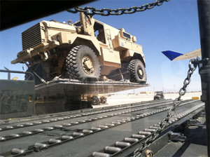"Photo of a Cougar being loaded into the accident airplane through the cargo door"