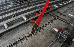 "Photo of an example strap and tie-down fitting installed in a cargo track Photo copyright Bob Rogers ULD CARE - used with permission"