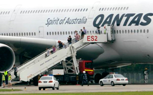 "Photo of passengers offloading onto runway - ATSB accident report. Photo supplied by Air Accident Investigation Bureau of Singapore"