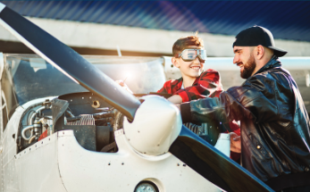 man and child with small plane