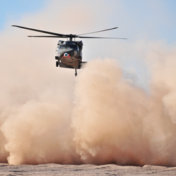 Helicopter with a dust cloud behind it