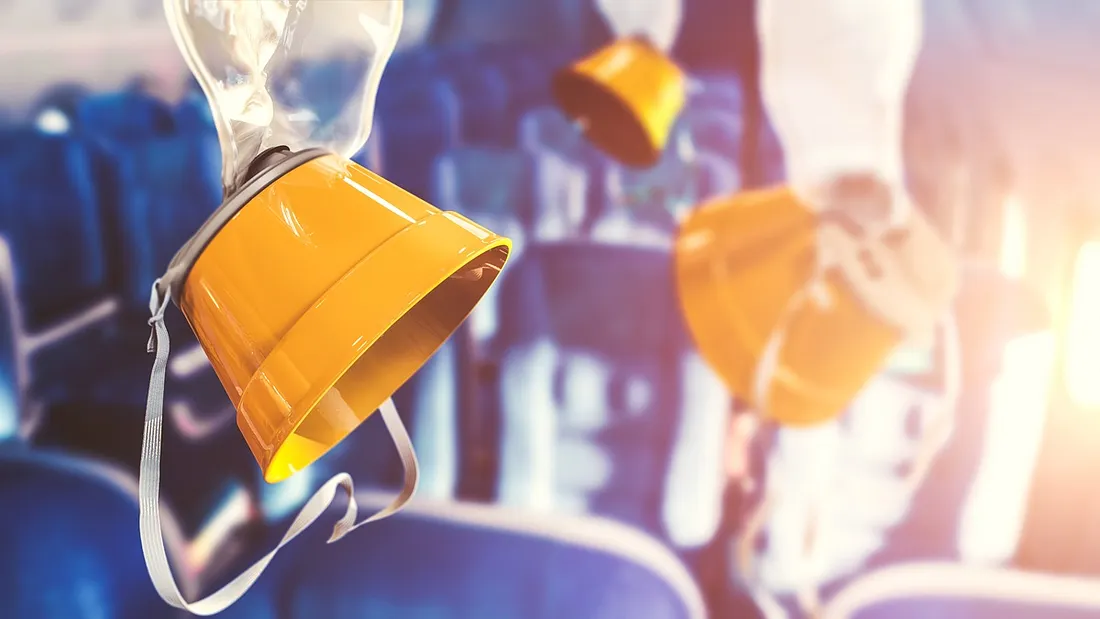Oxygen masks deployed on a commercial airliner.