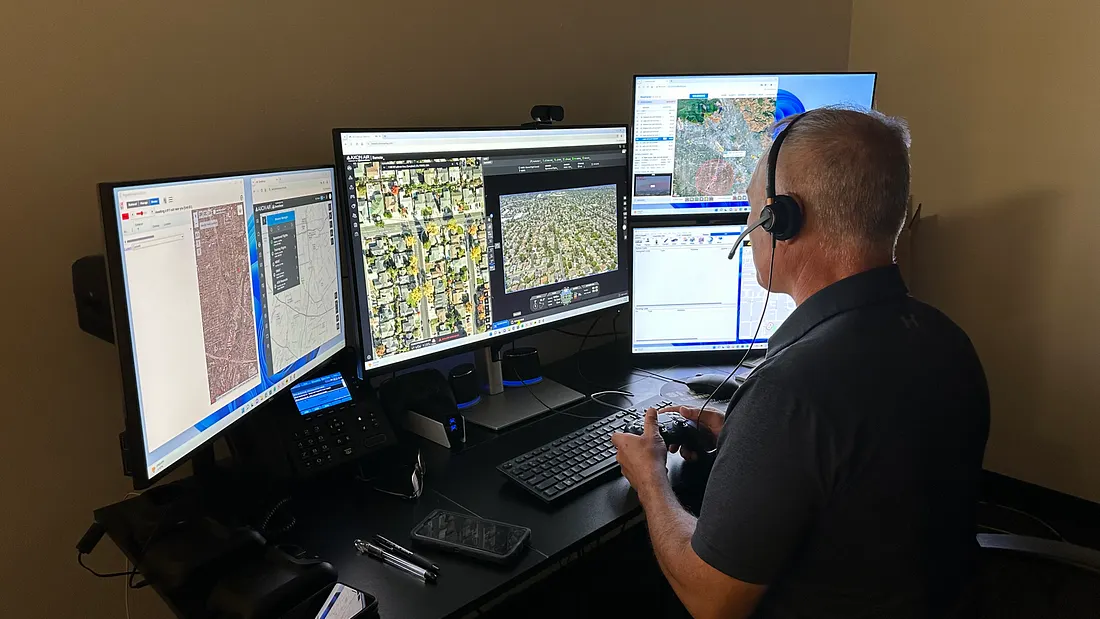 An officer and certified drone operator at Campbell Police Department in northern California flies a drone remotely from the department’s flight room, where they can view live footage captured by the drone and rooftop-mounted cameras. (Photo courtesy of Campbell PD)