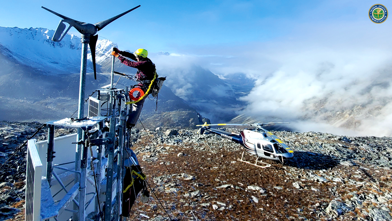 A technician maintains a remote mountaintop weather camera site in Alaska. This is one of 299 FAA weather cameras across the United States that help pilots be aware of conditions in near-real time so they can fly more safely. (Photo: FAA)
