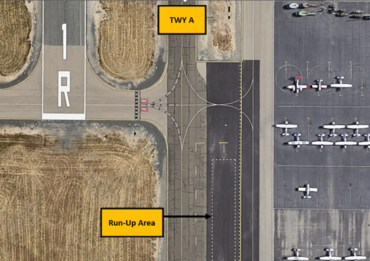 Picture shows the run-up area for RWY 01R. It is located east of TWY A, south of TWY F between TWY A and the large ramp area to the east
