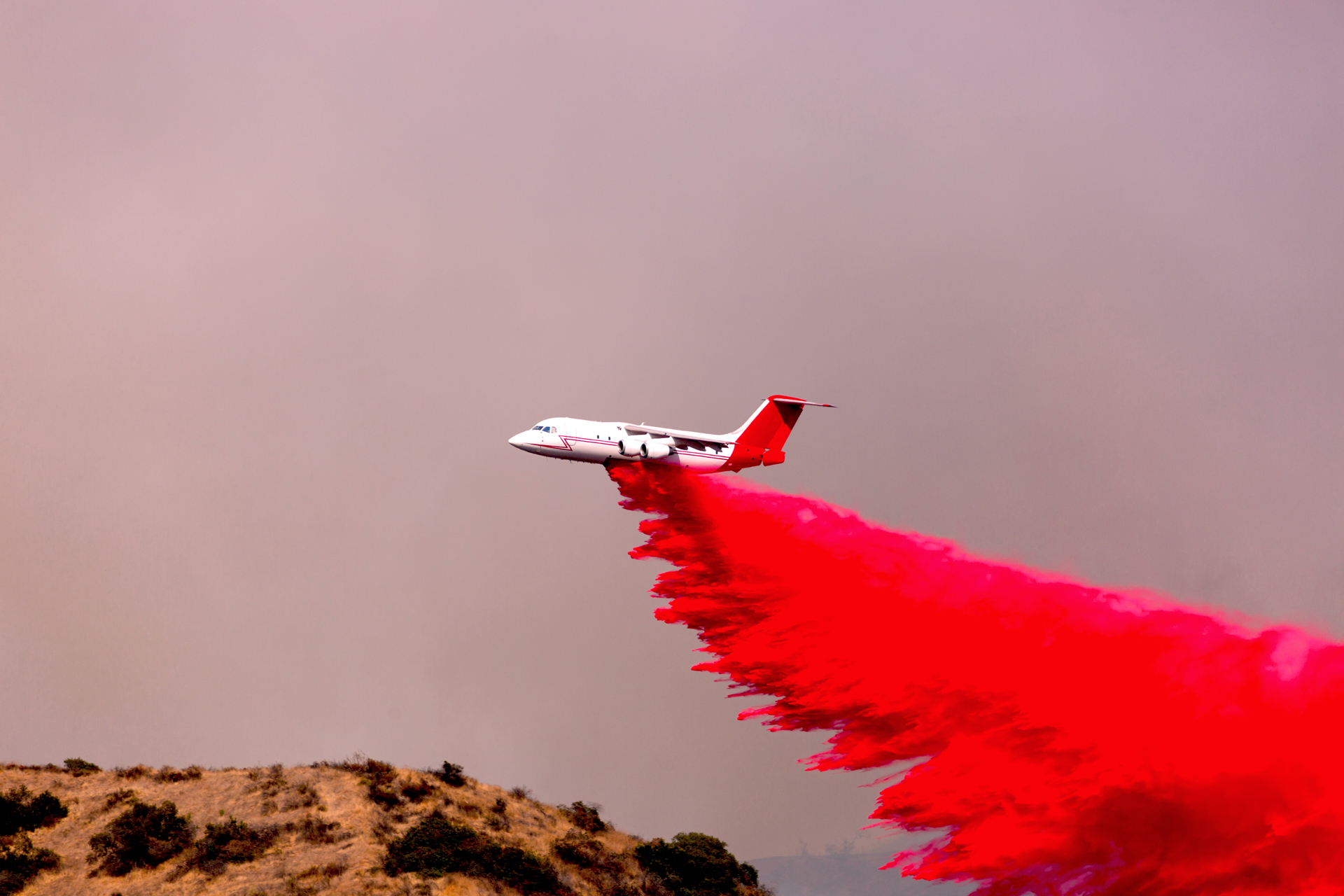 plane conducting intentional disbursement, this can be done for pest control, plant nourishment, soil treatment, or other agricultural products