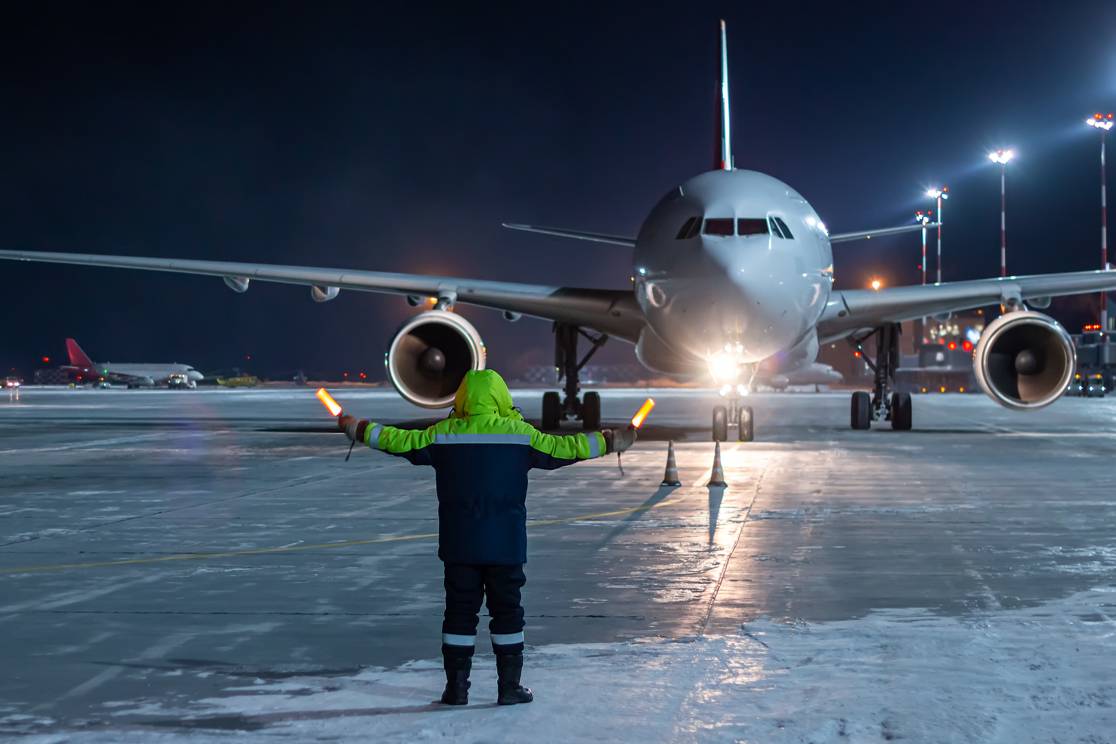 air traffic controller directing plane at night