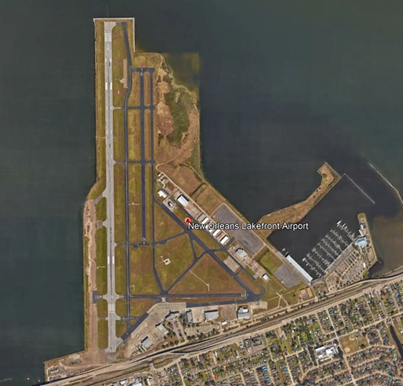 Illustration of Lakefront airport surrounded on three sides by water.