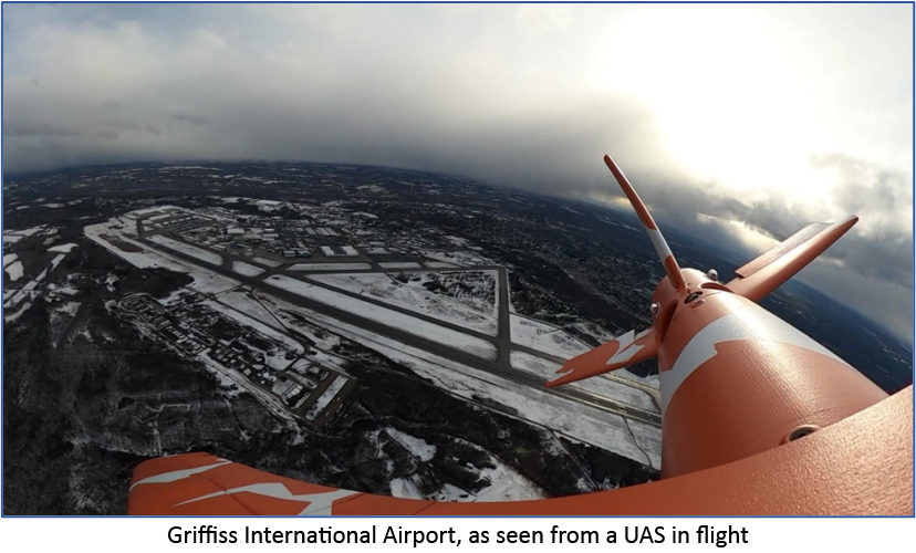 aerial photo of drone flying over an airport, snow on the ground