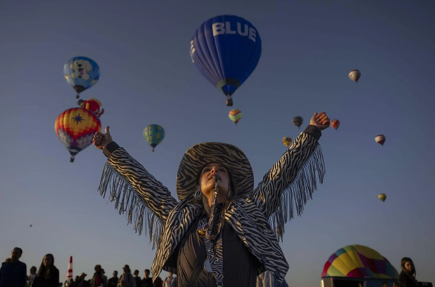 Launch Director Nicole Tagart directs balloon pilots at the festival. (Photo: Chancey Bush, Albuquerque Journal)