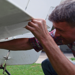man inspecting an aircraft