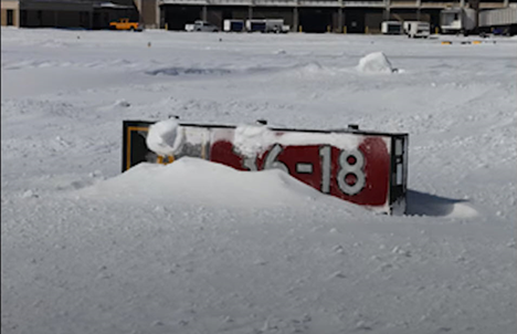 Runway sign buried in snow
