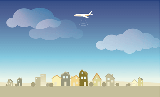 An airplane flying over homes in a community