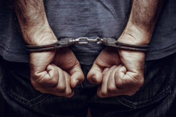 person in handcuffs