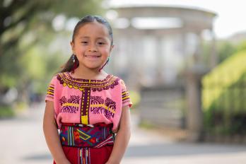 little girl in front of school