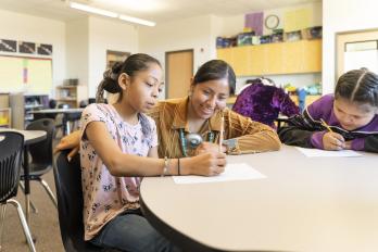 child and teacher in school