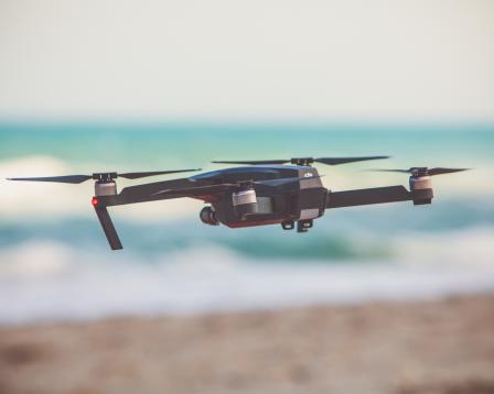 drone flying over a beach