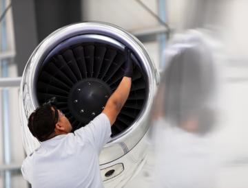 man working on airplane engine