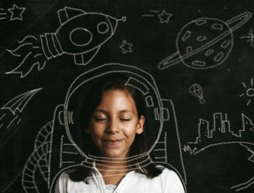 little girl in front of chalkboard