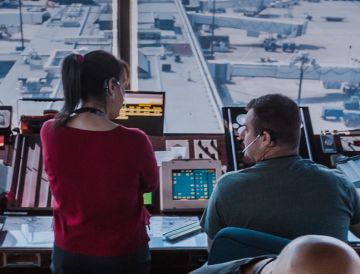 man and woman air traffic controller in tower