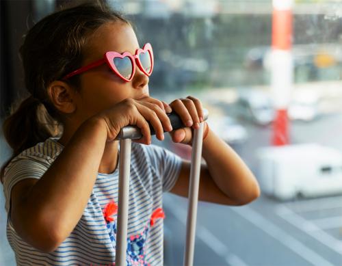a small child with their luggage getting ready to fly on the plane