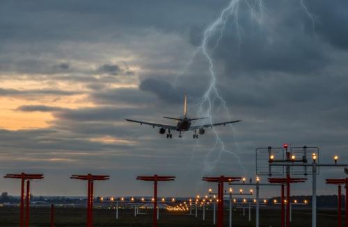 an airplane flying with bad weather in the background