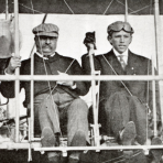 President Theodore Roosevelt (left) and pilot Arch Hoxsey (right) seated in Hoxsey's Wright (Co) Type AB (head on view, close-up) prior to making a flight at Kinloch Field, St. Louis, Missouri, October 11, 1910; this was the first flight of an American president.