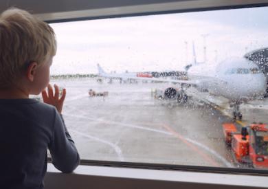 child looking out rainy window