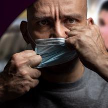 Man removing his mask on a flight