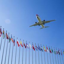aircraft flying over international flags